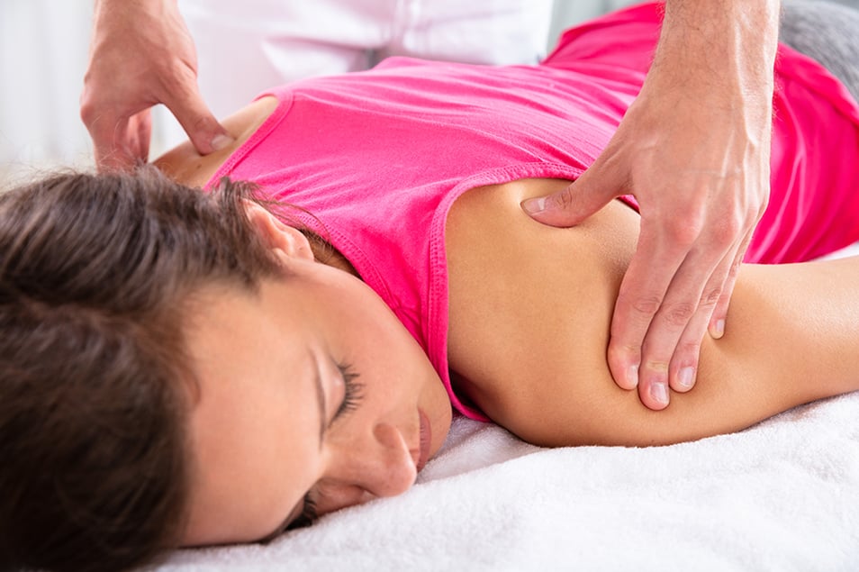 Woman getting massage by doctor