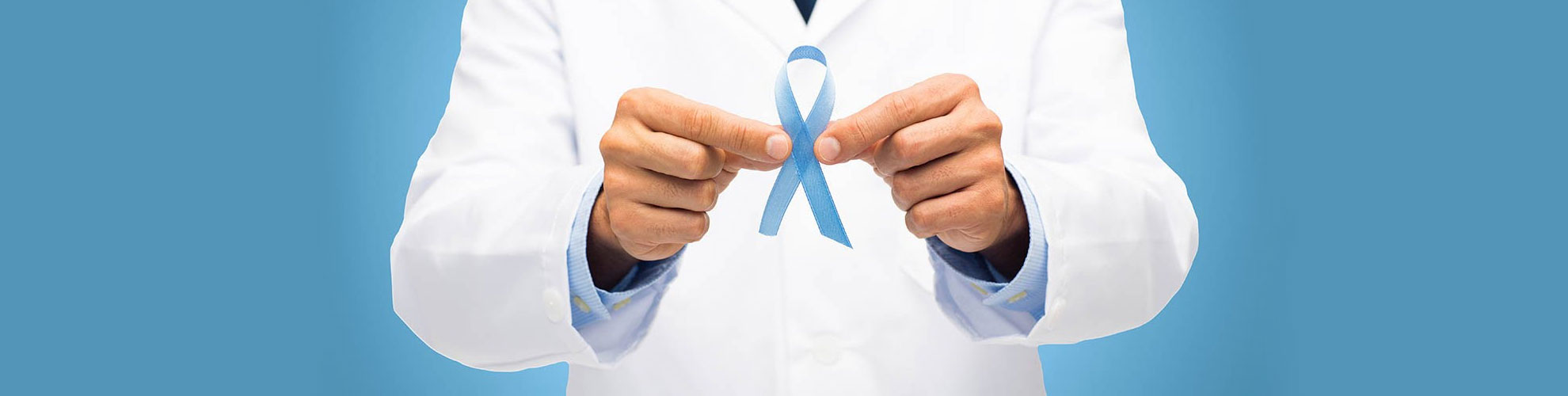 Doctor holding up blue cancer ribbon