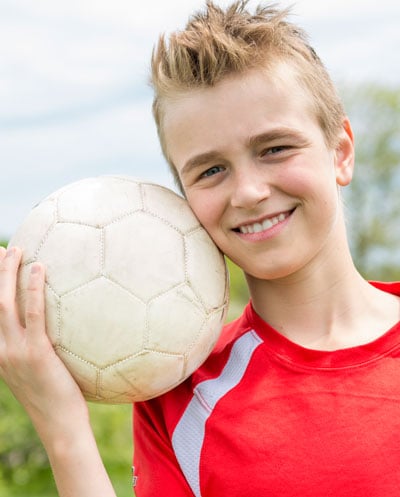 Happy young boy with soccer ball